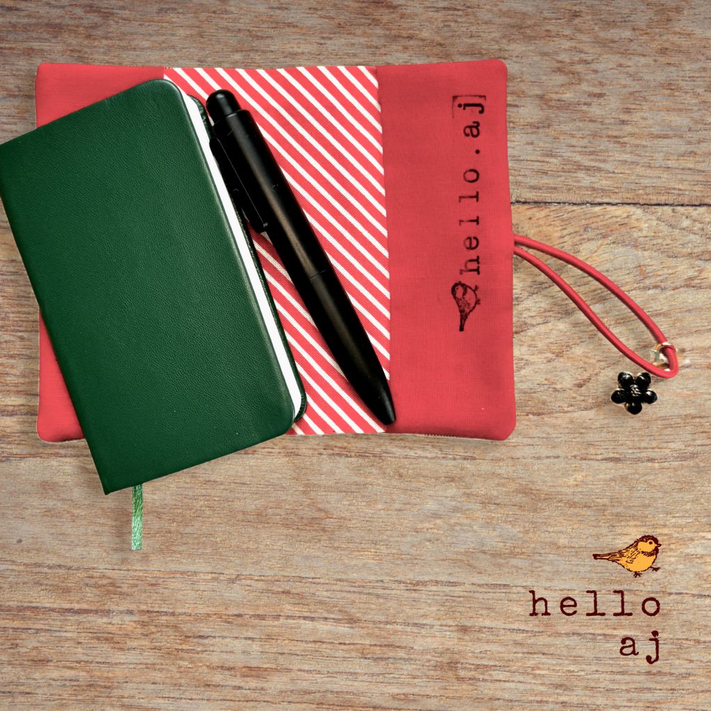 navy and gold handmade journal cover on notebook with pen and red elastic strap – hello.aj