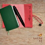 navy and gold handmade journal cover on notebook with pen and red elastic strap – hello.aj