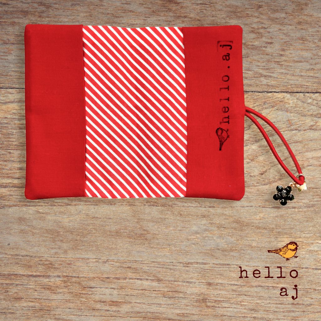 handmade journal cover open flat showing red and white striped interior lining – hello.aj