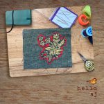 handmade navy tweed journal cover with gold floral applique shown with sewing notions – hello.aj